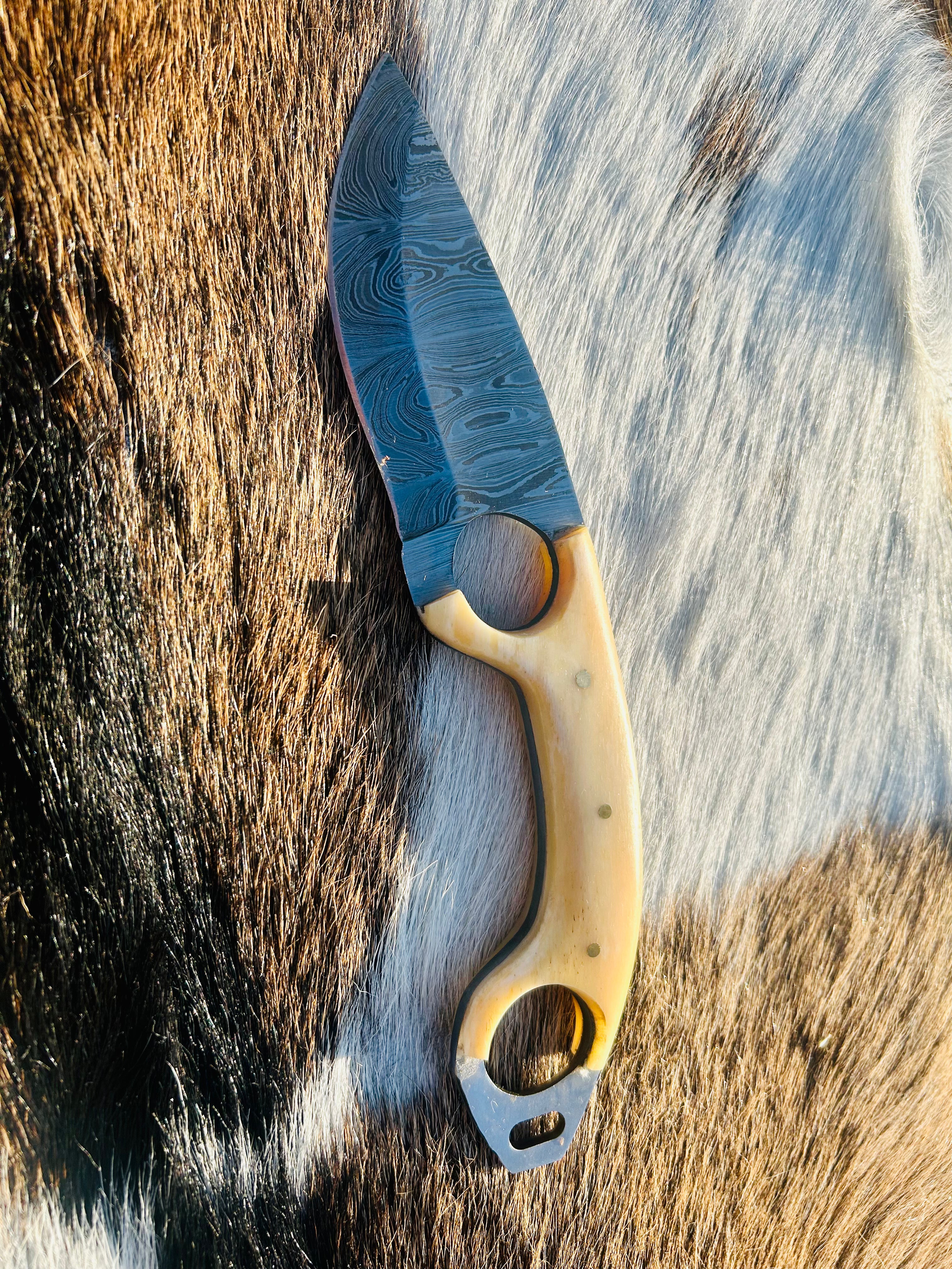 Bone handle with natural texture and steel pins visible
