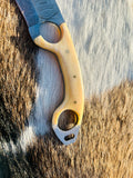 Damascus knife with bone handle closeup look