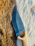 Bone handle with natural texture and steel pins visible