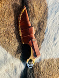 Knife and sheath photographed for protection from moisture and sunlight