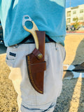 Damascus knife inside leather sheath help as camping gear for camping