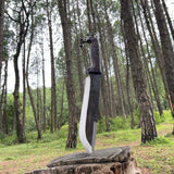 Decorative Nepali sword on a wooden stump in a forest for survival
