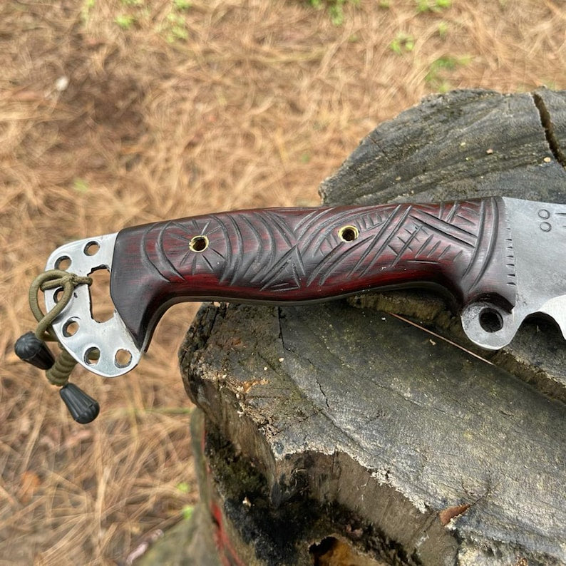 Sharp Gurkha Khukuri Knife with a decorative wooden handle on a wooden stump