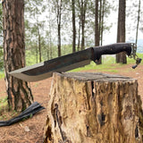 Khukuri Knife with a black handle on a wooden stump in a forest camp
