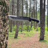 Sharp Gurkha Khukuri knife hanging on a tree in a forest