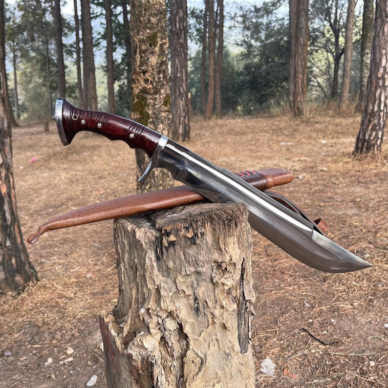 Long knife with wooden handle and leather sheath on a tree stump in a forest for camping and protection