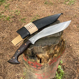 Knife with leather sheath on a tree stump outdoors