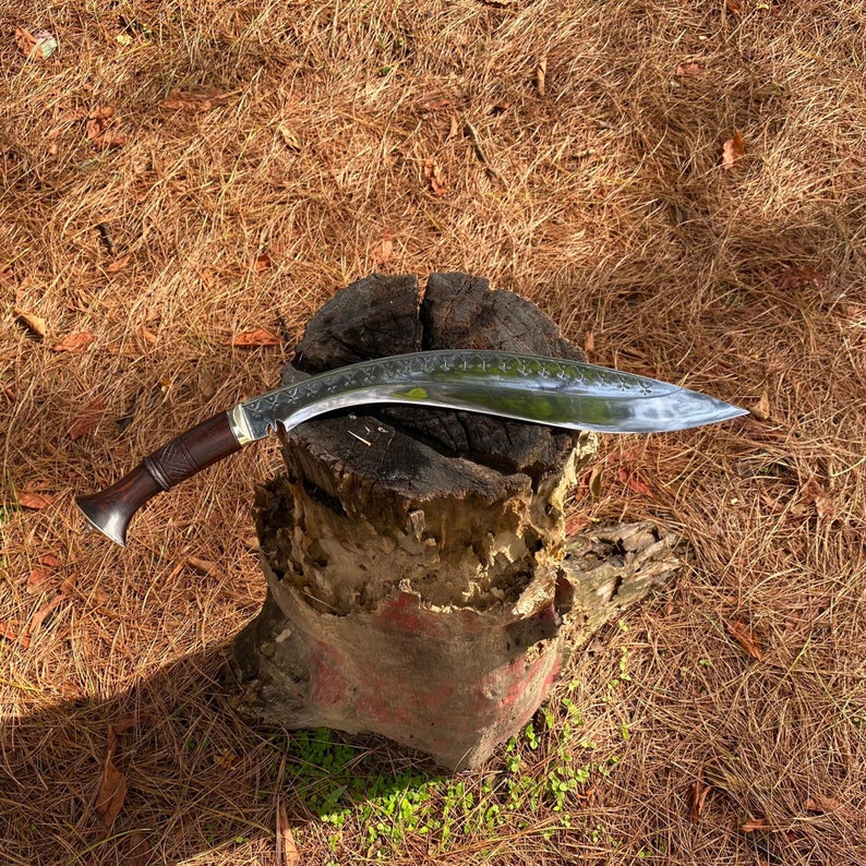 Decorative salyani khukuri with a wooden handle on a textured surface