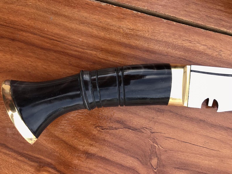 Black and gold object on a wooden surface closeup look
