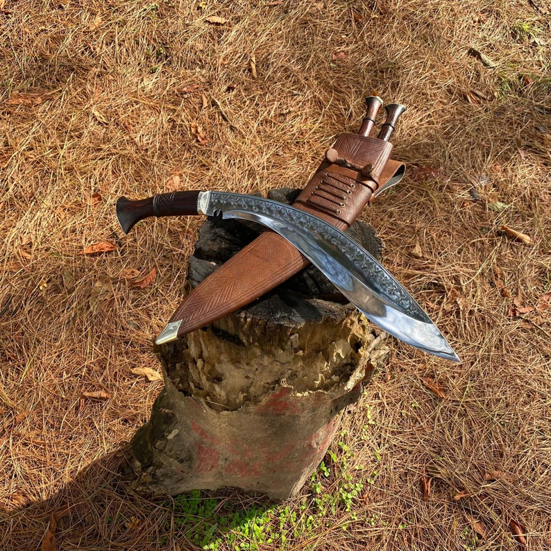15-inch Salyani kukri knife on wooden plank hand-forged blade detail with leather sheath