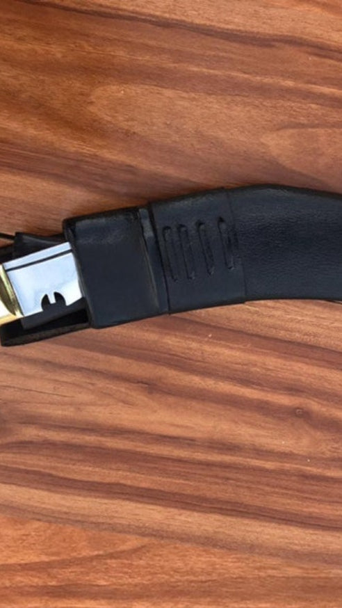 Well polished Black kukri knife with gold accents on a wooden surface