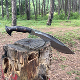 Kukri knife on a wooden stump in a forest background power testing and durability
