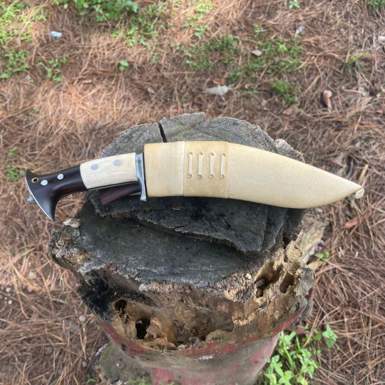 Full‑tang rosewood handle of hand‑forged Chukukri secured with pins