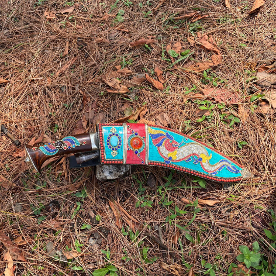 3 chirra khukuri knife inside beautiful sheath laying in ground