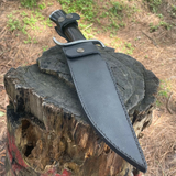 Hand-forged khukuri blade displayed with sheath