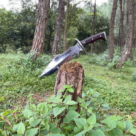 Tikau Kukri knife chopping wood outdoors, showcasing its survival and hunting capability