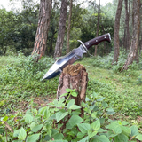 Tikau Kukri knife chopping wood outdoors, showcasing its survival and hunting capability