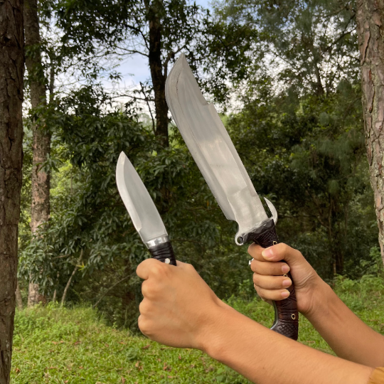 Person holding bajyu handmade machete and small machete used for easy and heavy task like camping, chopping woods.