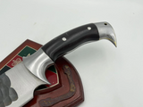 hand-forged Bowie knife with brown rosewood handle, displayed next to its scabbard.
