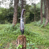 Tikau Kukri knife chopping wood outdoors, showcasing its survival and hunting capability