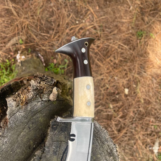 Full‑tang rosewood handle of hand‑forged Chukukri secured with pins