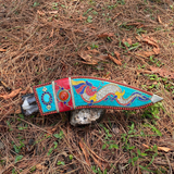 beautiful sheath with dragon design laying on grass in forest showcase