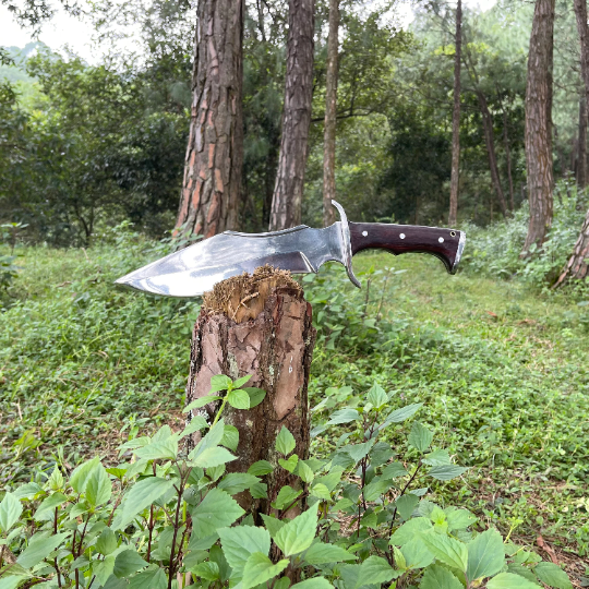 Tikau Kukri knife chopping wood outdoors, showcasing its survival and hunting capability