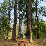 Traditional handmade cleaver knife from Nepal on wooden log shining and sharp blade