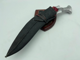 A 12 inch hand forged kukri with a polished blade and a brass handle, accompanied by a black leather scabbard.