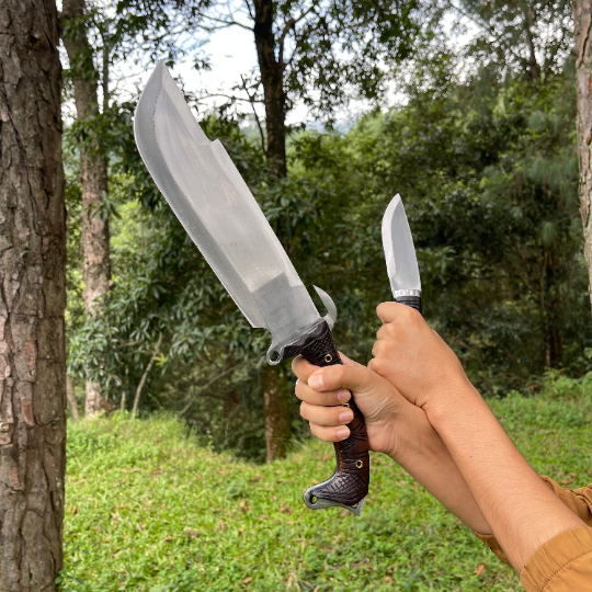 Person holding bajyu handmade machete and small machete used for easy and heavy task like camping, chopping woods.
