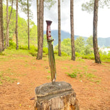Knife with a wooden handle on a tree stump in a forest setting