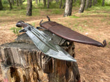Knife with a sheath on a wooden stump in a forest setting