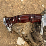 Wooden-handled knife with metal blade on a rocky surface with perfect texture and design