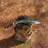 Decorative salyani khukuri with a wooden handle on a textured surface