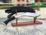 Two knives on a wooden stand with 'Famous Baraka' branding in the background.