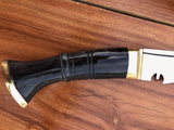 Black and gold object on a wooden surface closeup look