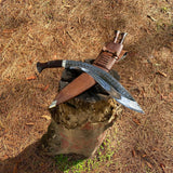 15-inch Salyani kukri knife on wooden plank hand-forged blade detail with leather sheath