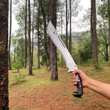 Person holding a large machete knife in a forest setting for camping and protection