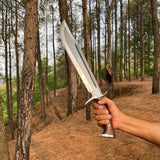 Close-up of differential tempered blade showing Seax-style edge and polished handle