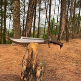Drawn out bushcraft knife half-sheathed in buffalo leather for outdoor ready use