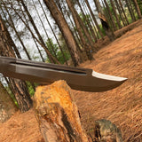 Knife on a log with a forest background