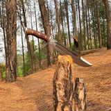 Long knife with wooden handle on a tree stump in a forest setting