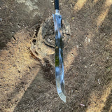 Long knife with a metallic blade on a dirt ground