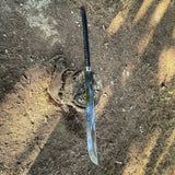 Weapon embedded in a log on a dirt ground