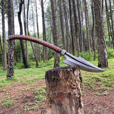 Long axe with a wooden handle on a tree stump in a forest setting