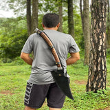 Person in a forest holding a large axe on their back