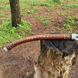Wooden handle with silver accents on a tree stump in a natural setting