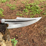 Decorative spearhead on a wooden handle with a natural background