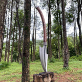 Decorative long axe handle on a wooden stump in a forest setting
