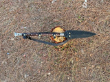Spear on a wooden block with a natural background